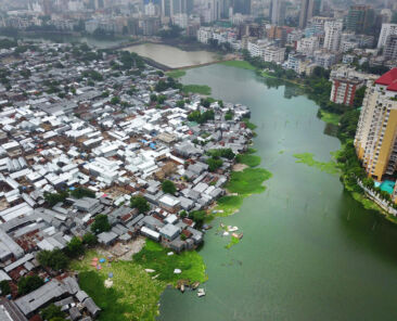 Aerial view of the slum of Koreil and surrounding neighborhoods of Dhaka. Dhaka is chocked by its 16 min residents. 400,000 people migrate from farmlands to Dhaka every year 70% of them quote environmental shock as a main reason for migration. These families usually end up in the poorest, most flood-prone areas of the city where they live in a constant fear of another flood. Photo by Frank Sedlar