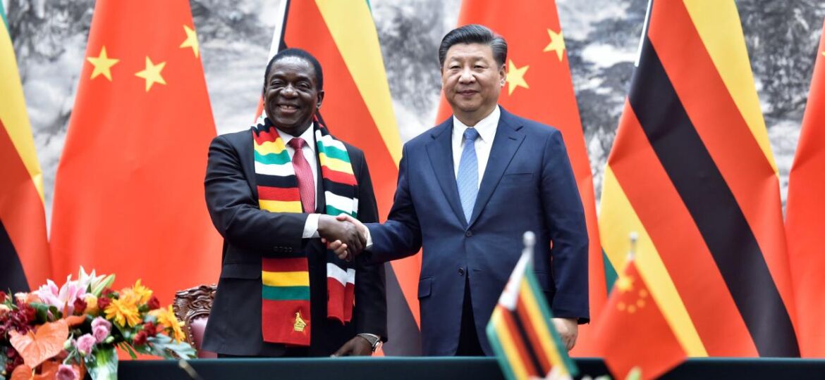Chinese President Xi Jinping shakes hands with Zimbabwean President Emmerson Mnangagwa as they pose for the media after a signing ceremony at the Great Hall of the People in Beijing