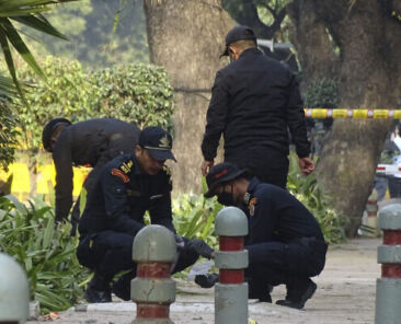 National Security Guard soldiers inspect the site of a blast near the Israeli Embassy in New Delhi, India, Saturday, Jan. 30, 2021. A “very low intensity” device exploded Friday near the Israeli Embassy in the Indian capital, but there were no injuries and little damage, police said. (AP Photo/Dinesh Joshi)