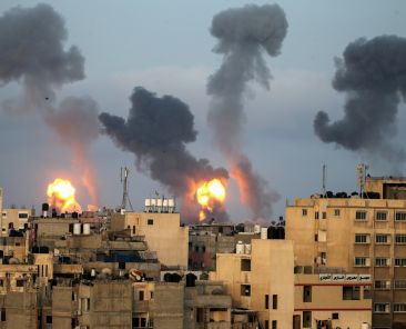 FILE PHOTO: Flames and smoke rise during Israeli air strikes amid a flare-up of Israel-Palestinian violence, in the southern Gaza Strip May 11, 2021. REUTERS/Ibraheem Abu Mustafa