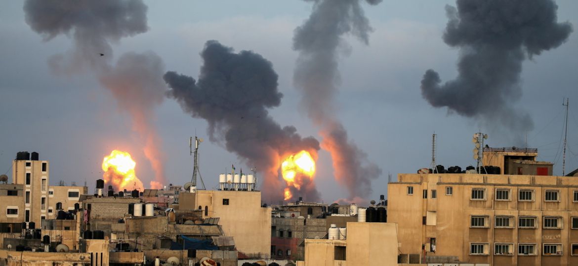 FILE PHOTO: Flames and smoke rise during Israeli air strikes amid a flare-up of Israel-Palestinian violence, in the southern Gaza Strip