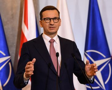 FILE PHOTO: Polish Prime Minister Mateusz Morawiecki gestures as he speaks during a joint news conference with Britain's Prime Minister Boris Johnson (unseen) in Warsaw, Poland February 10, 2022 following a meeting. Daniel Leal/Pool via REUTERS/FIle Photo