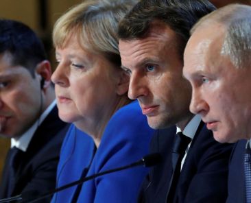 Ukraine's President Volodymyr Zelenskiy, German Chancellor Angela Merkel, French President Emmanuel Macron and Russia's President Vladimir Putin attend a press conference after a summit on Ukraine at the Elysee Palace, in Paris, on December 9, 2019. - Leaders aim for new withdrawal of forces from Ukraine conflict zones by March 2020, according to a communique on December 9, 2019. (Photo by CHARLES PLATIAU / POOL / AFP) (Photo by CHARLES PLATIAU/POOL/AFP via Getty Images)