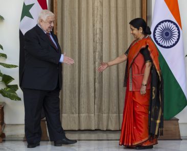 Syrian Deputy Prime Minister and Foreign Minister Walid al-Moallem, left, and Indian External Affairs Minister Sushma Swaraj extend their hands to greet each other in New Delhi, India, Tuesday, Jan. 12, 2016. Al-Moallem is on a four-day official visit to India. (AP Photo/Saurabh Das)