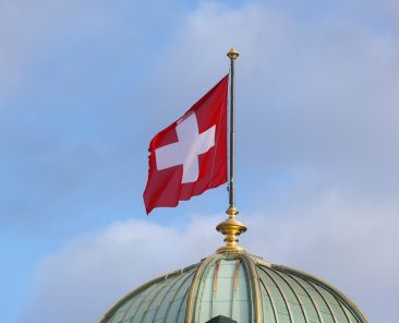 FILE PHOTO: The flag of Switzerland flies on the dome of the Parliament Building (Bundeshaus), as the spread of the coronavirus disease (COVID-19) continues, in Bern, Switzerland October 28, 2020. REUTERS/Arnd Wiegmann