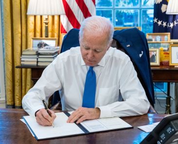 U.S. President Joe Biden signs an executive order to prohibit trade and investment between U.S. individuals and the two breakaway regions of eastern Ukraine recognized as independent by Russia, at the White House in Washington, U.S., February 21, 2022. The White House/Handout via REUTERS