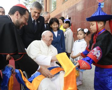 A boy gives Pope Francis scarves as he arrives at the headquarters of the Apostolic Prefecture of Ulaanbaatar, Mongolia, Sept. 1, 2023. Cardinal Giorgio Marengo, the prefect, will host the pope at the prefecture during his four-day visit to the country. (CNS photo/Vatican Media)