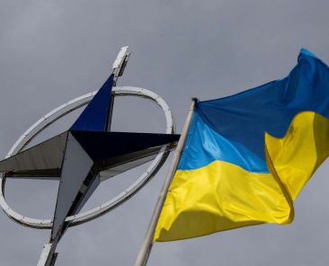 A Ukrainian national flag rises in front of the NATO emblem, amid Russia's attack on Ukraine, in central Kyiv, Ukraine July 11, 2023. REUTERS/Valentyn Ogirenko
