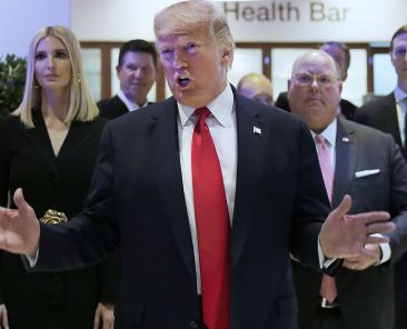 U.S. President Donald Trump reacts after addressing the World Economic Forum in Davos, Switzerland, Tuesday, Jan. 21, 2020. The 50th annual meeting of the forum will take place in Davos from Jan. 21 until Jan. 24, 2020. Left is Ivanka Trump. (AP Photo/Markus Schreiber)
