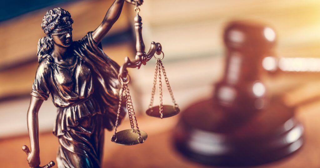 Law concept - Themis statue, judge hammer and books.