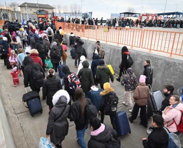 People coming from Ukraine descend from a ferry boat to enter Romania after crossing the Danube river at the Isaccea-Orlivka border crossing between Romania and Ukraine on February 26, 2022, as Ukrainians flee their country following Russia's invasion of Ukraine. (Photo by Daniel MIHAILESCU / AFP) (Photo by DANIEL MIHAILESCU/AFP via Getty Images)
