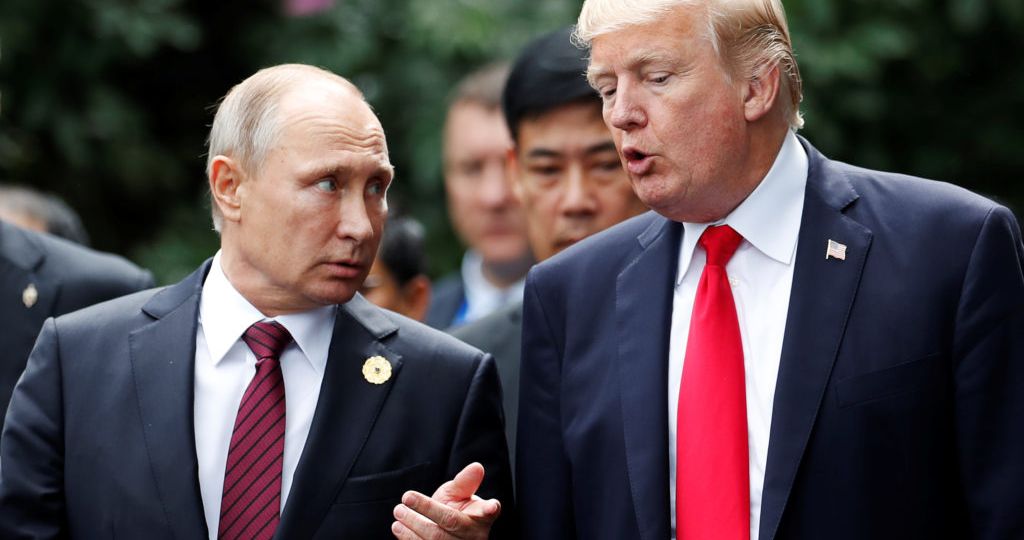 U.S. President Donald Trump and Russia's President Vladimir Putin talk during the family photo session at the APEC Summit in Danang, Vietnam