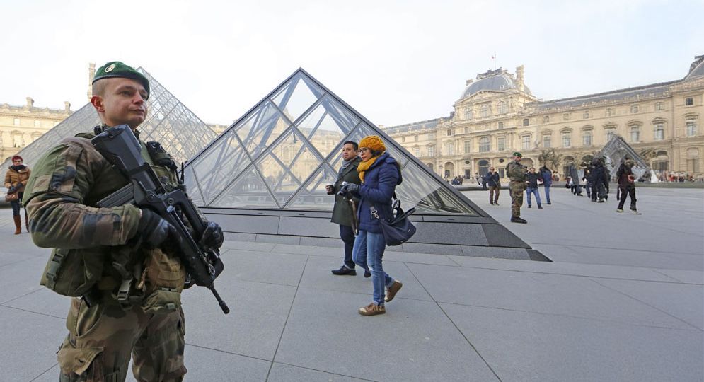 Armed French soldiers patrol at the Louvre Museum as emergency security measures continue ahead of New Year's eve celebrations in and around the French capital, in Paris